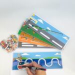 Réguas Psicomotoras da Materiais para Brincar, mostrando uma régua em MDF com um veículo sendo usado para traçar um caminho com um lápis.